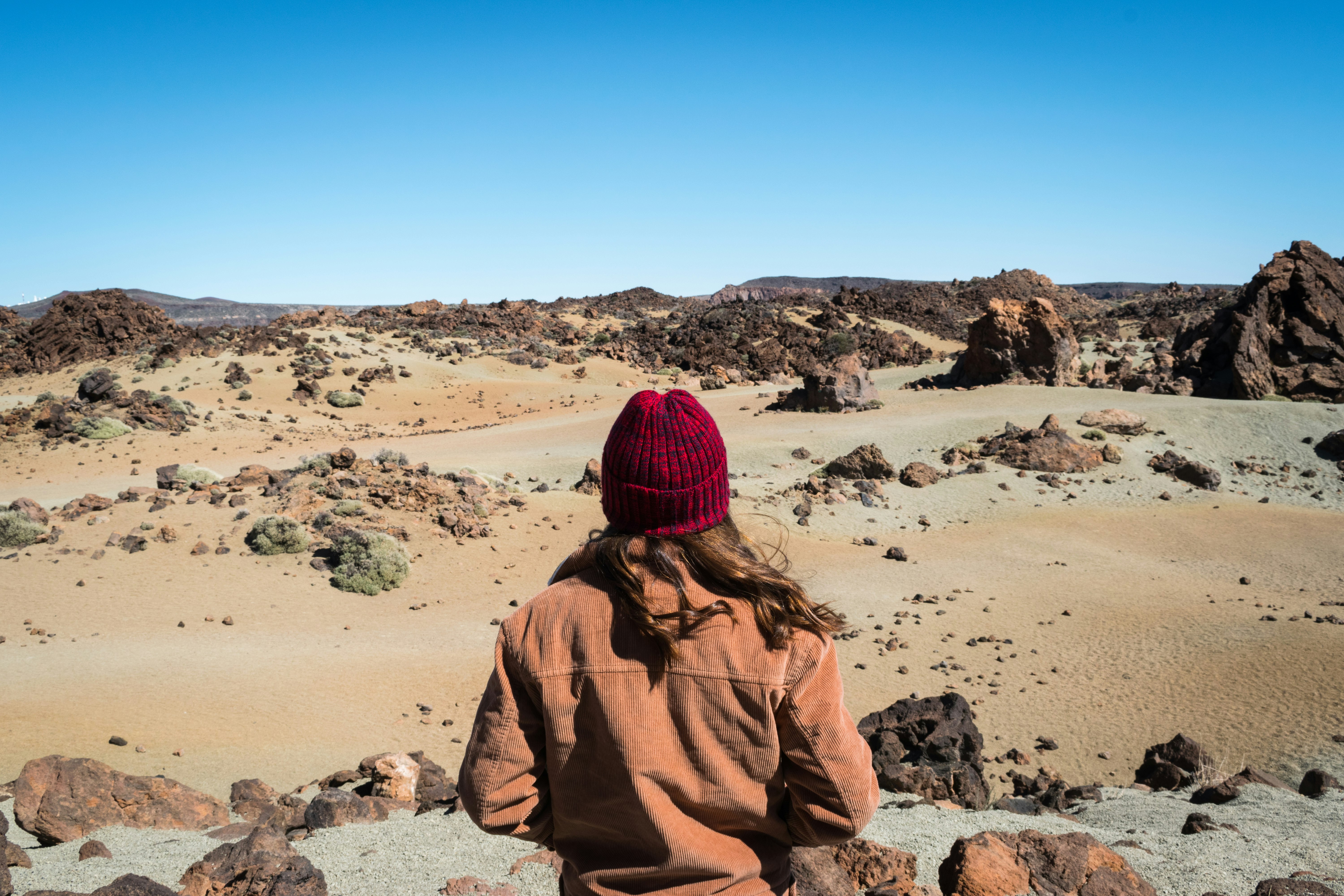 person standing in front of rock