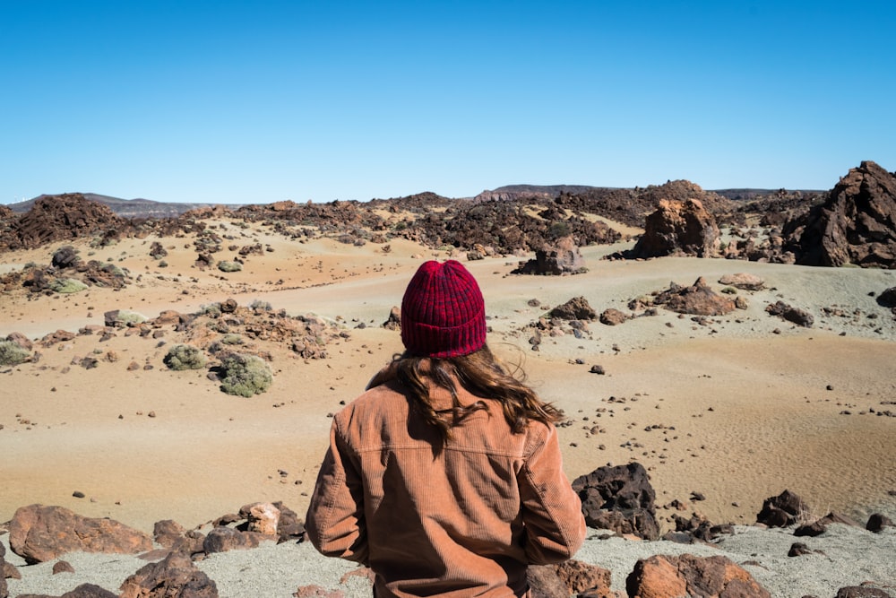 person standing in front of rock