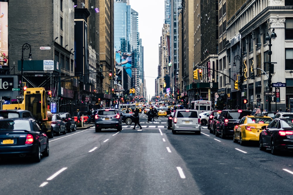 vehicles on road between buildings