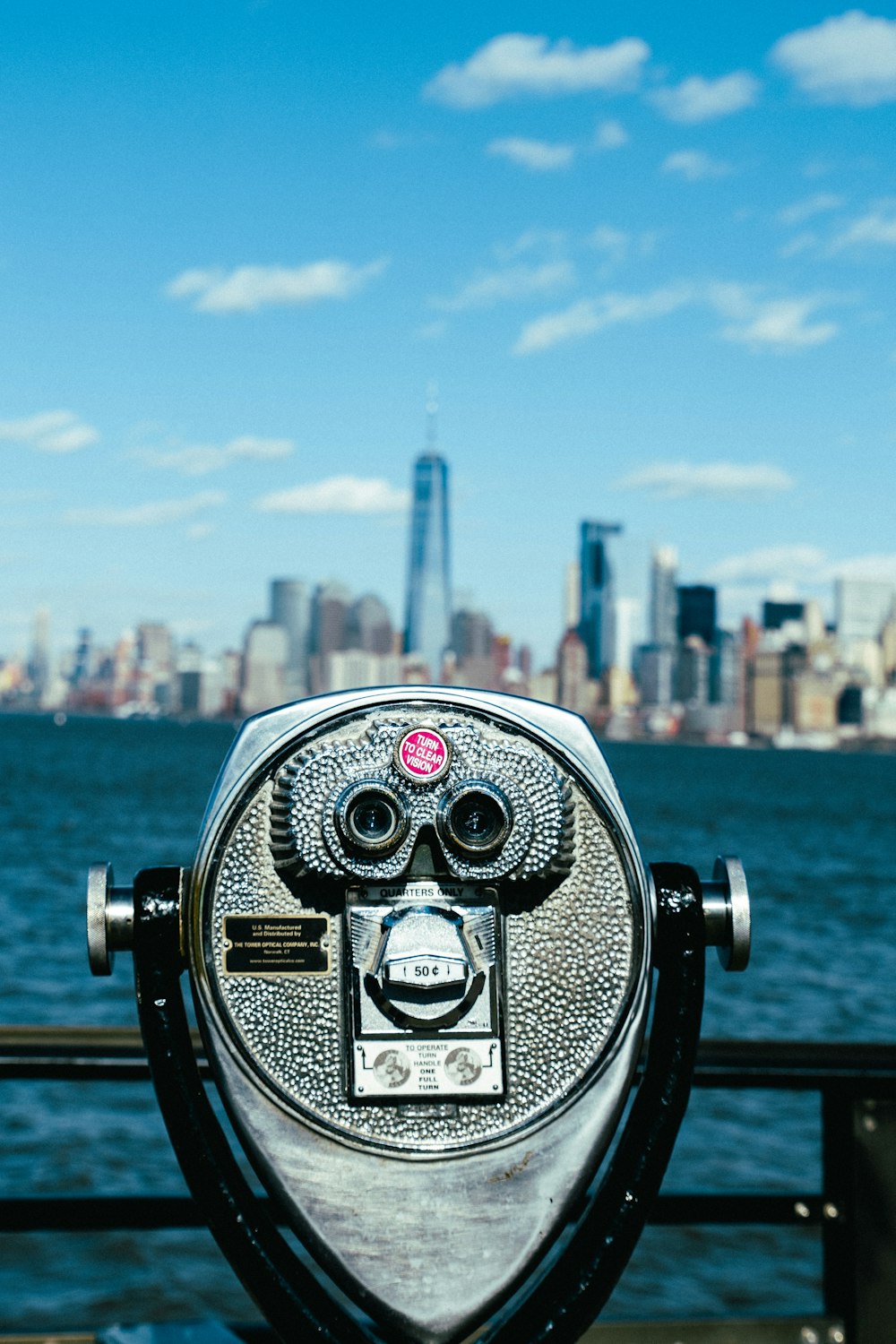 gray tower viewer facing the ocean and city during day