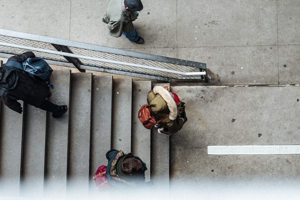 four person walking on stair