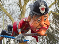 A caricature of a famous politician caught in a humorous situation involving a giant microphone.