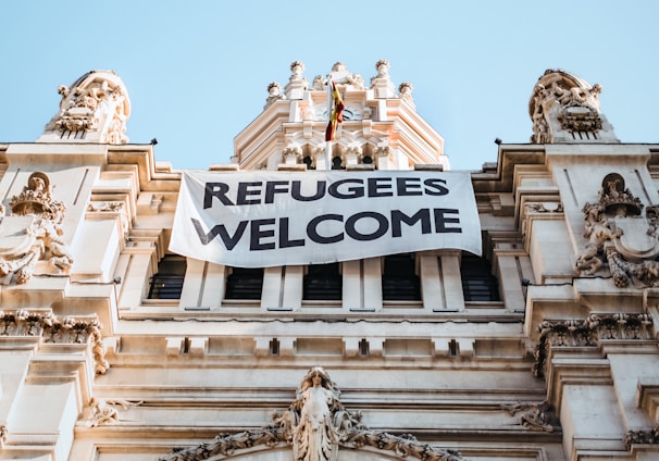 building with refugees welcome signage