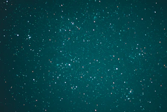 Portrait of Kelechi Iwuafor against a starry midnight navy background with subtle nebula highlights.