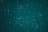 A vast expanse of the night sky is speckled with countless stars, creating a breathtaking celestial scene. The stars vary in brightness and are scattered across a deep, teal background, evoking a sense of wonder and the infinite nature of the universe.