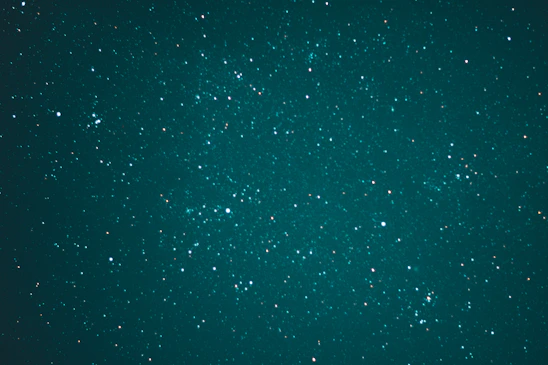 Portrait of Kelechi Iwuafor against a starry midnight navy background with subtle nebula highlights.