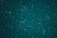 A vast expanse of the night sky is speckled with countless stars, creating a breathtaking celestial scene. The stars vary in brightness and are scattered across a deep, teal background, evoking a sense of wonder and the infinite nature of the universe.