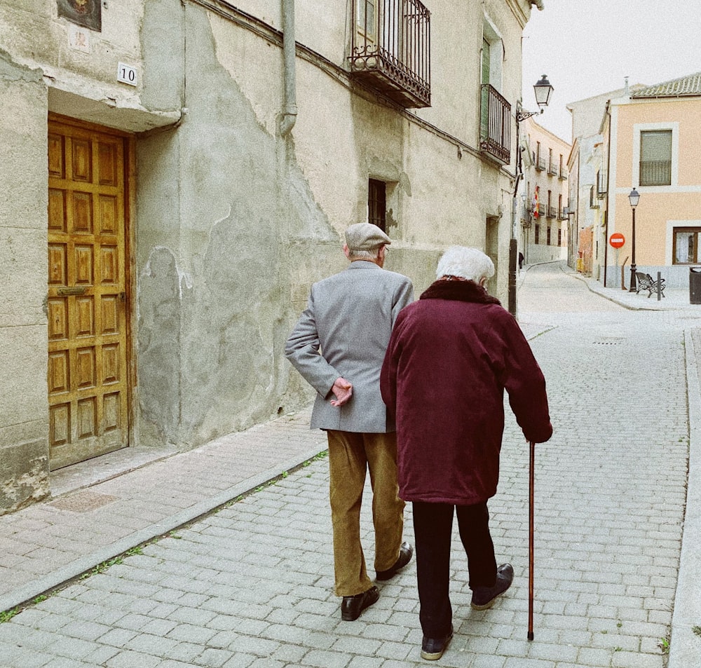 man and woman walking near closed wooden door