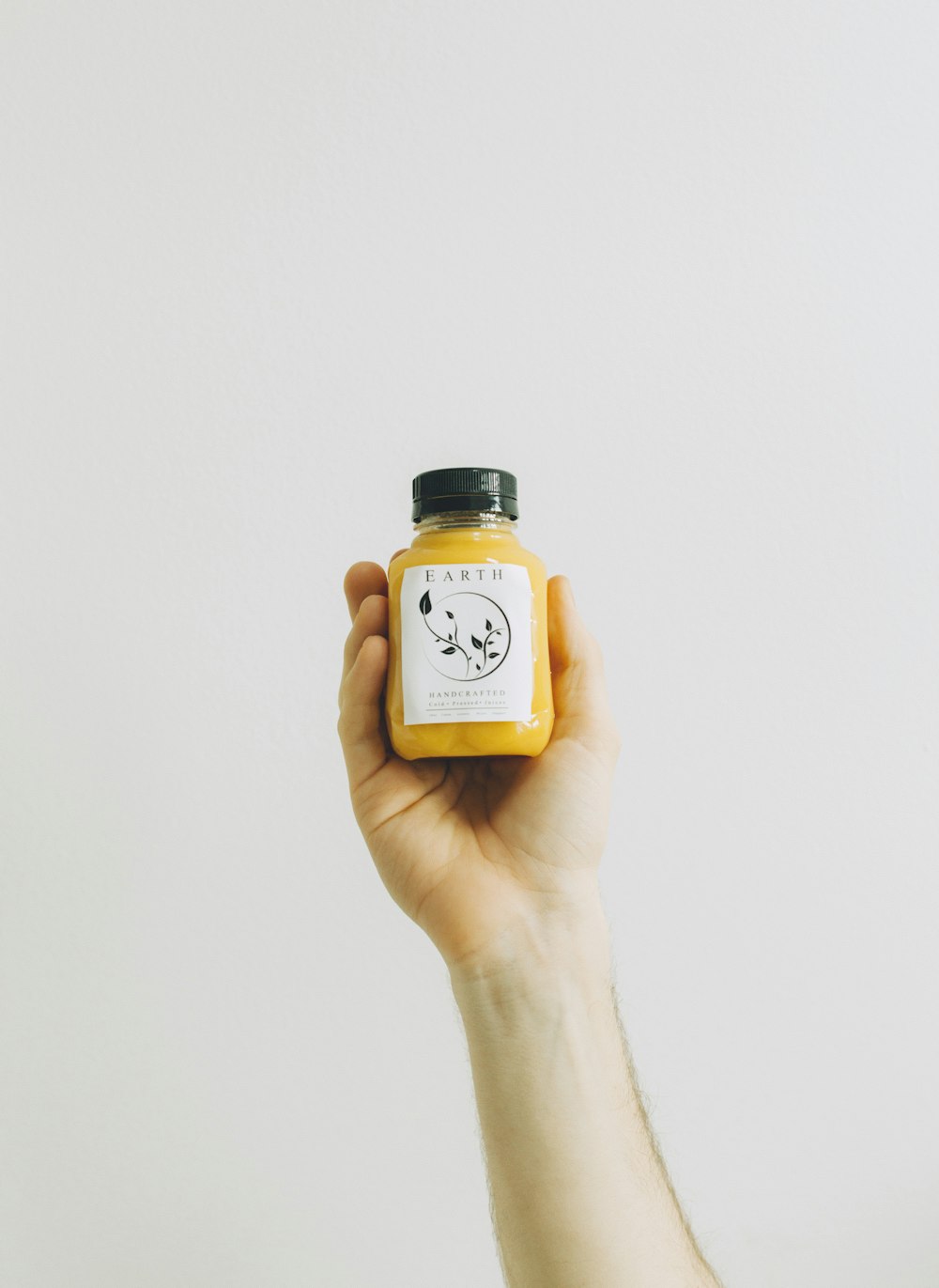 person holding white plastic jar