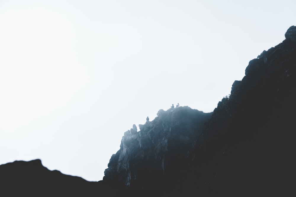 persons standing on mountain during daytime