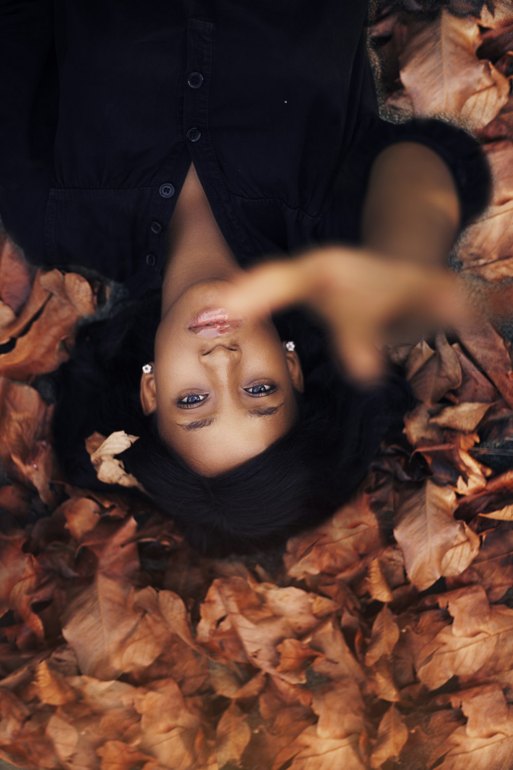 woman lying on leaves