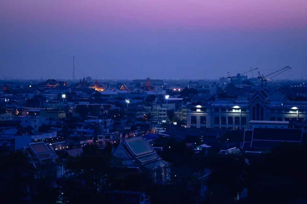 a view of a city at night from a hill