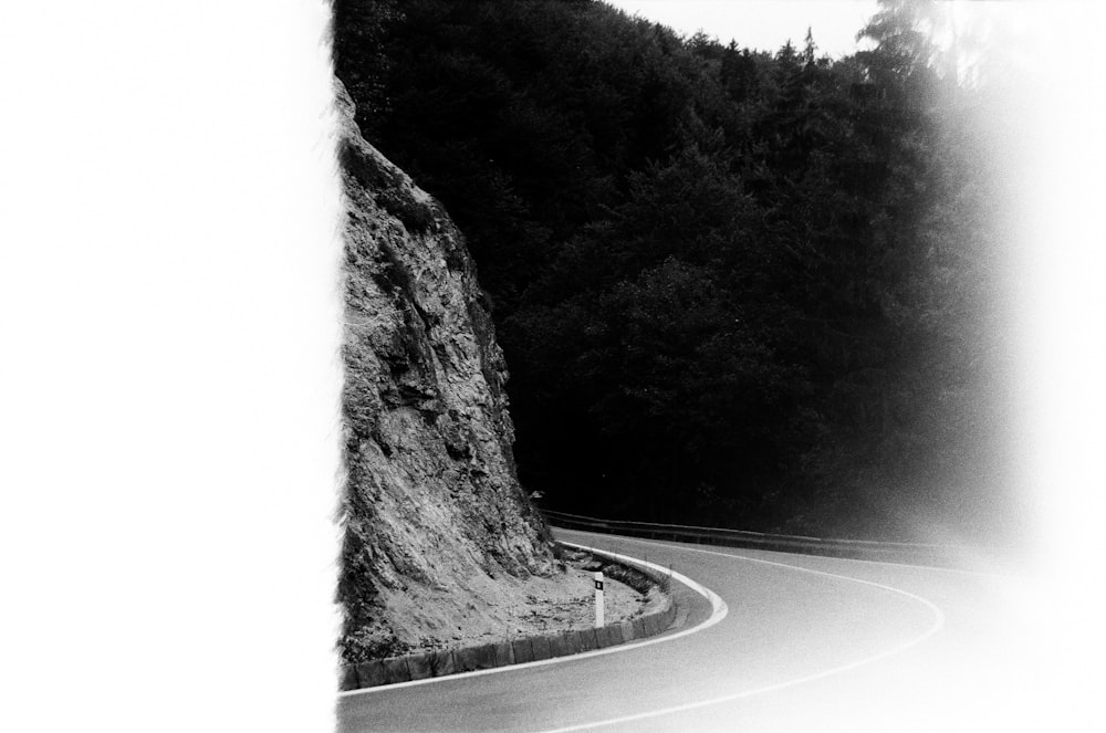 black and white photography of grey concrete curved road