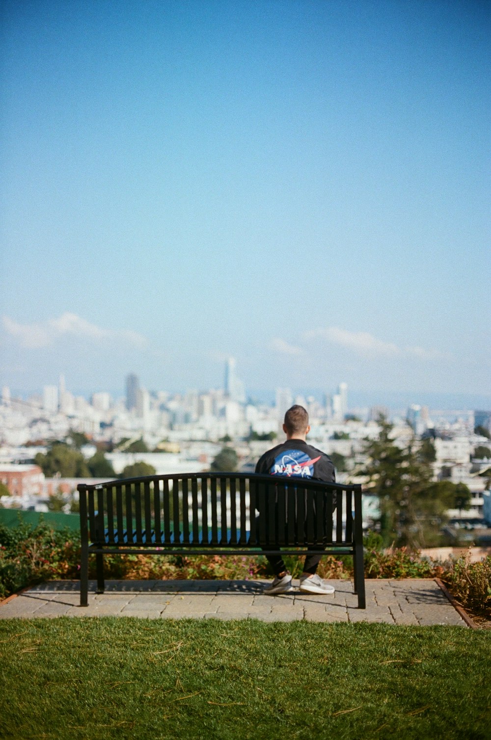 man sitting on bench during daytime
