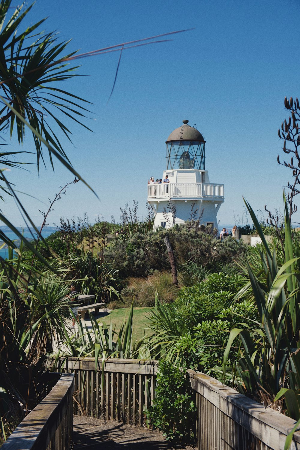 lighthouse near the ocean and bridge