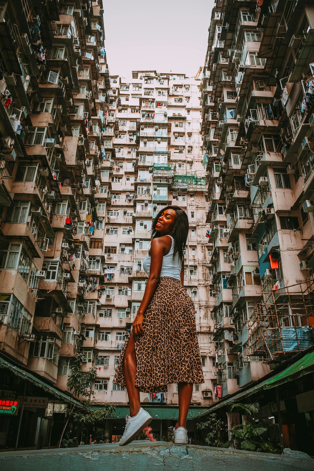 woman in blue top and brown skirt standing