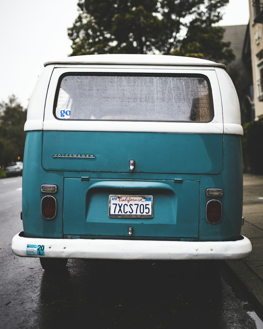 green and white van parking near road