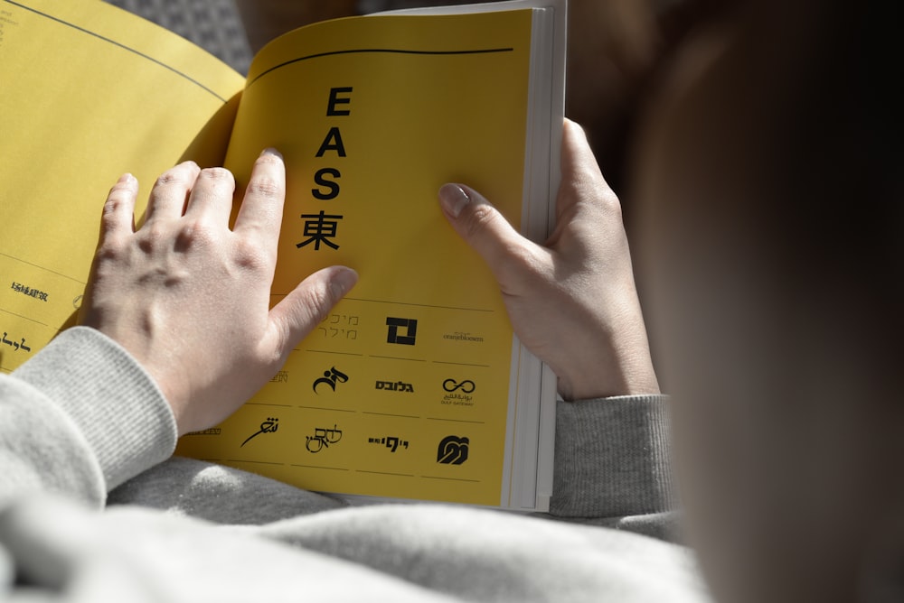 person holding opened book