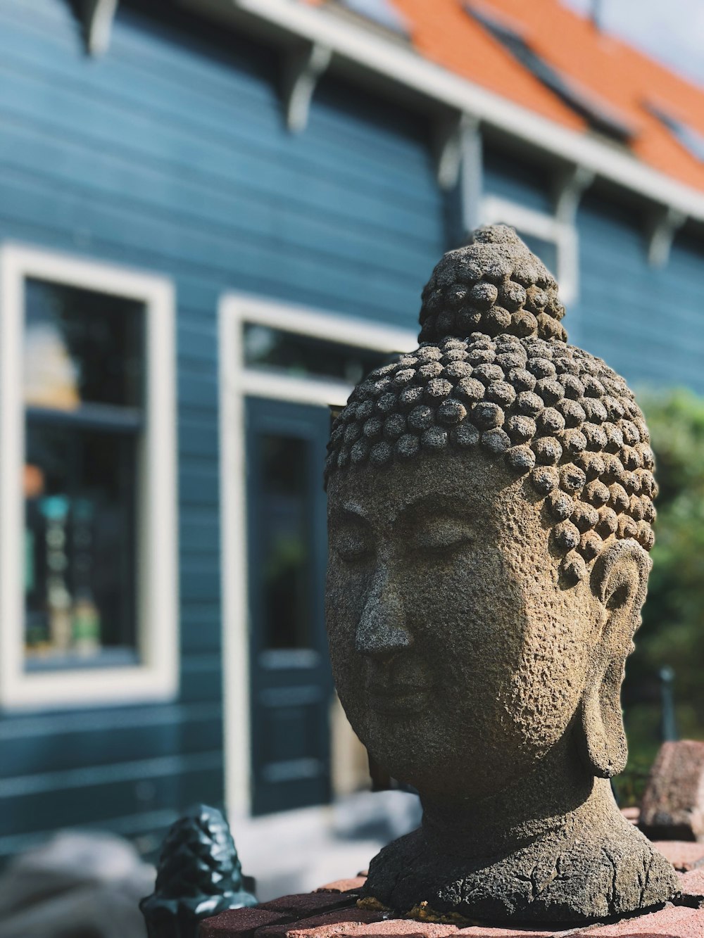 gray concrete Buddha headbust on table