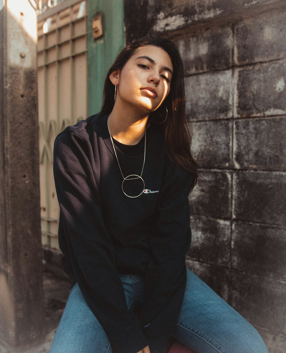 woman wearing black long-sleeved shirt and blue denim jeans