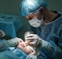 doctor conducting operation at patient in operating room