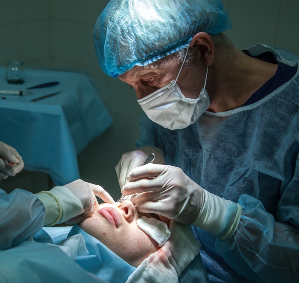doctor conducting operation at patient in operating room photo Free Hospital Image on Unsplash