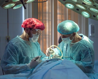 two men wearing blue lab coats