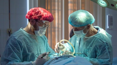 two men wearing blue lab coats