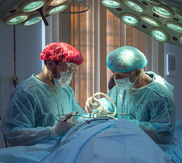 two men wearing blue lab coats