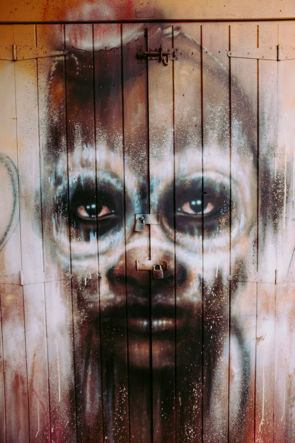 brown wooden human face graphic door