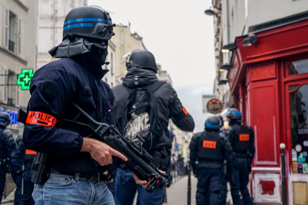 Police wearing black helmets and holding guns