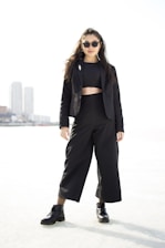 A stylish woman in a chic outfit, exuding confidence and allure in an urban setting.