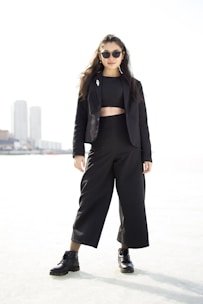 A confident woman stepping out in a sleek outfit blending casual and sophistication.