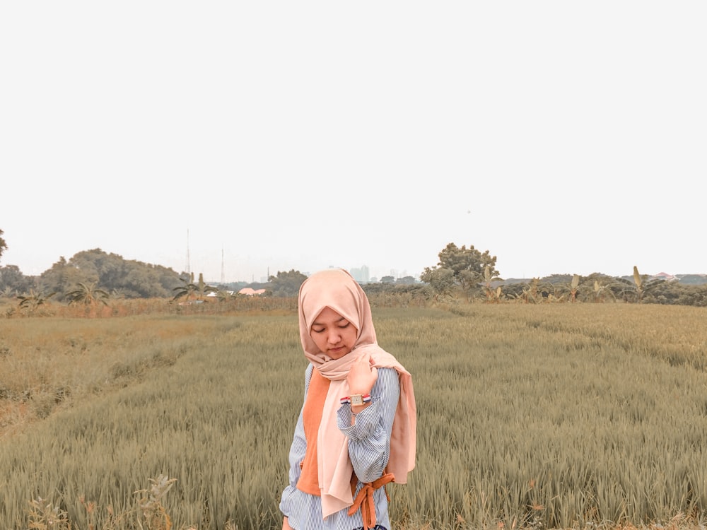 woman standing on green grass field