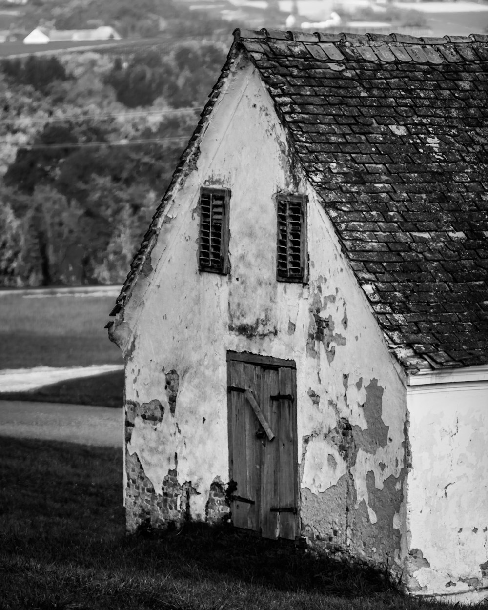 grayscale photo of brick house