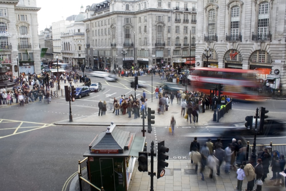 people walking at road beside concrete building