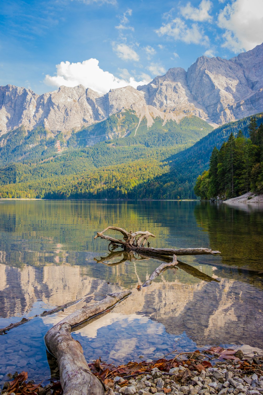 calm body of water near mountain