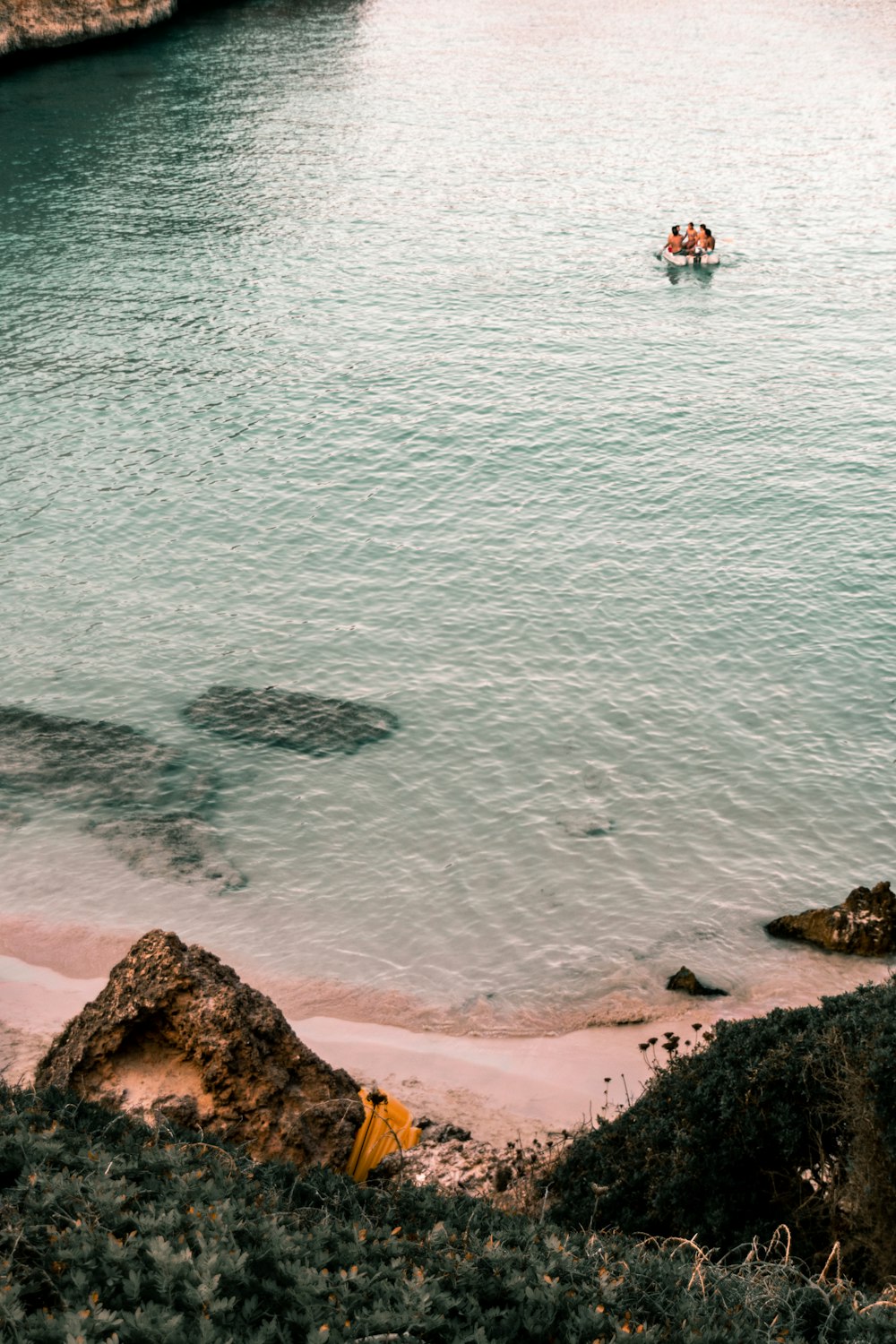 people swimming at beach during daytime