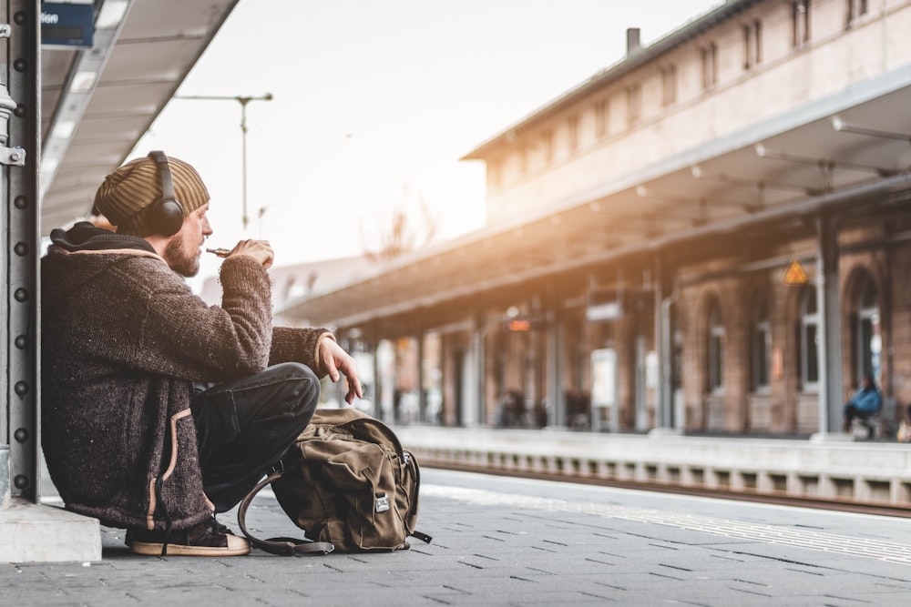 man sitting on train station