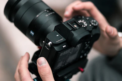 person holding black DSLR camera