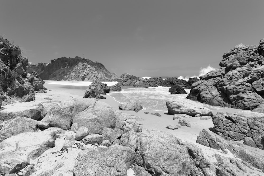 a black and white photo of rocks and snow