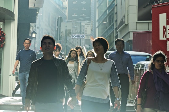 A diverse group of people walking briskly through a modern cityscape, symbolizing momentum and instant action.