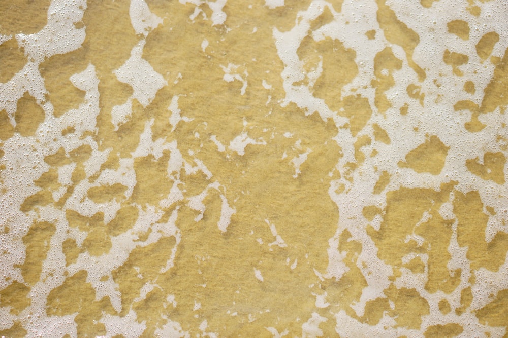 a close up of a yellow and white wall