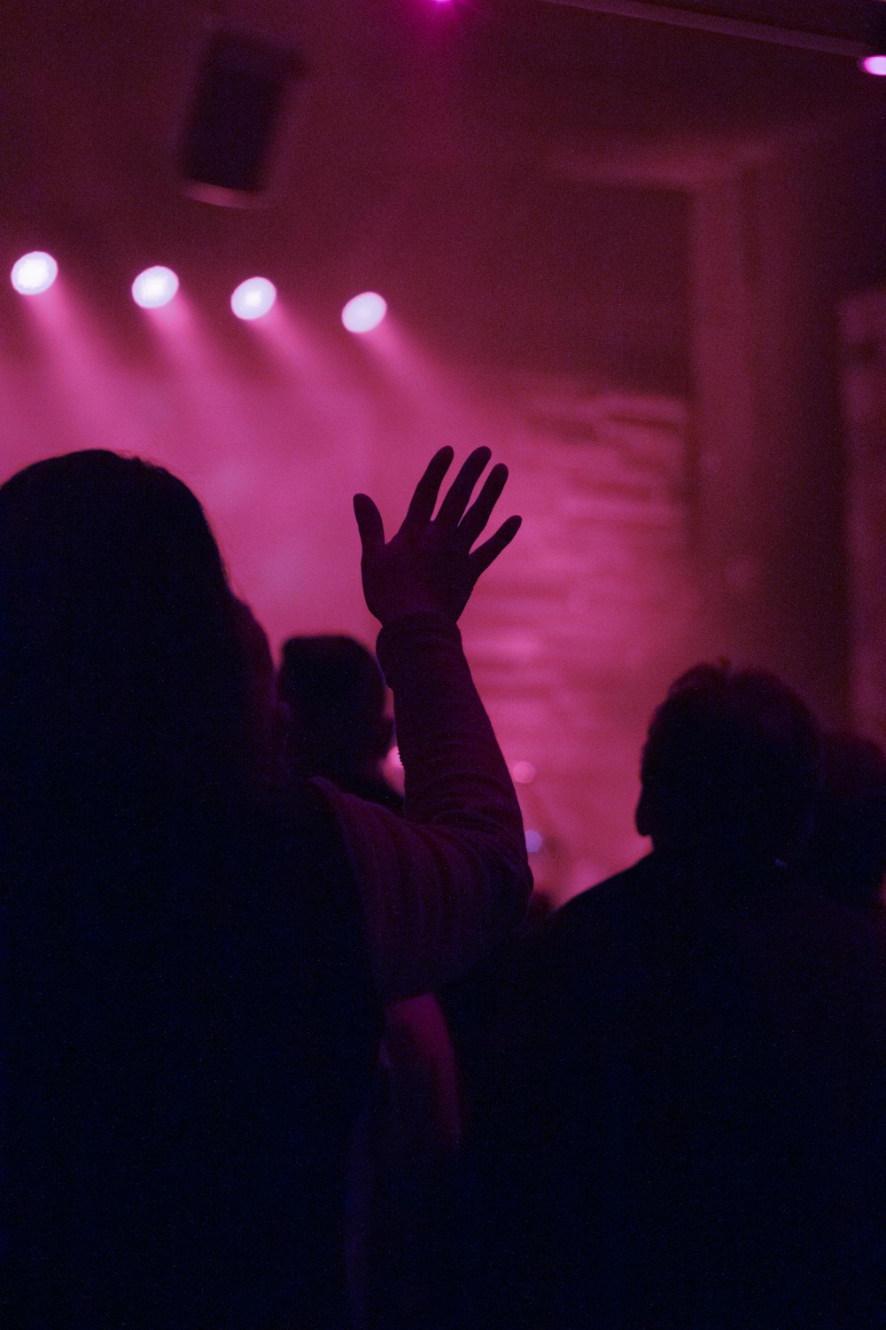 silhouette of person raising right hand