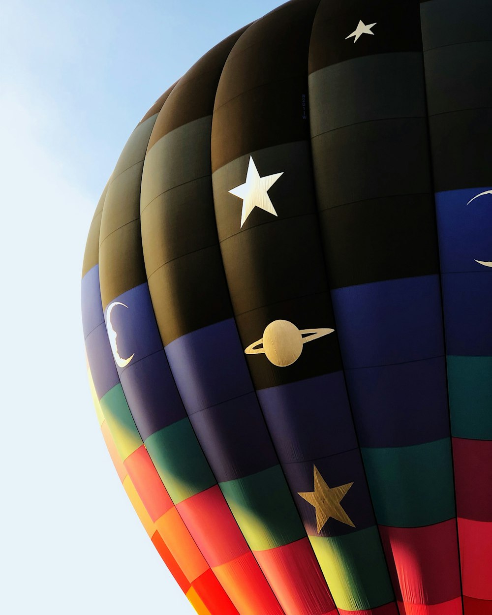 black, blue, and red hot air balloon during daytime