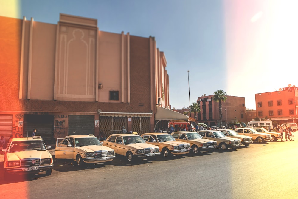 parked vehicles outside brown building during daytime