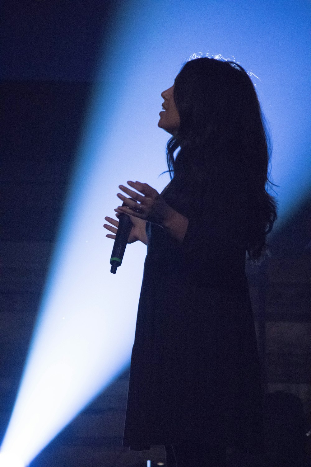 woman holding microphone on stage