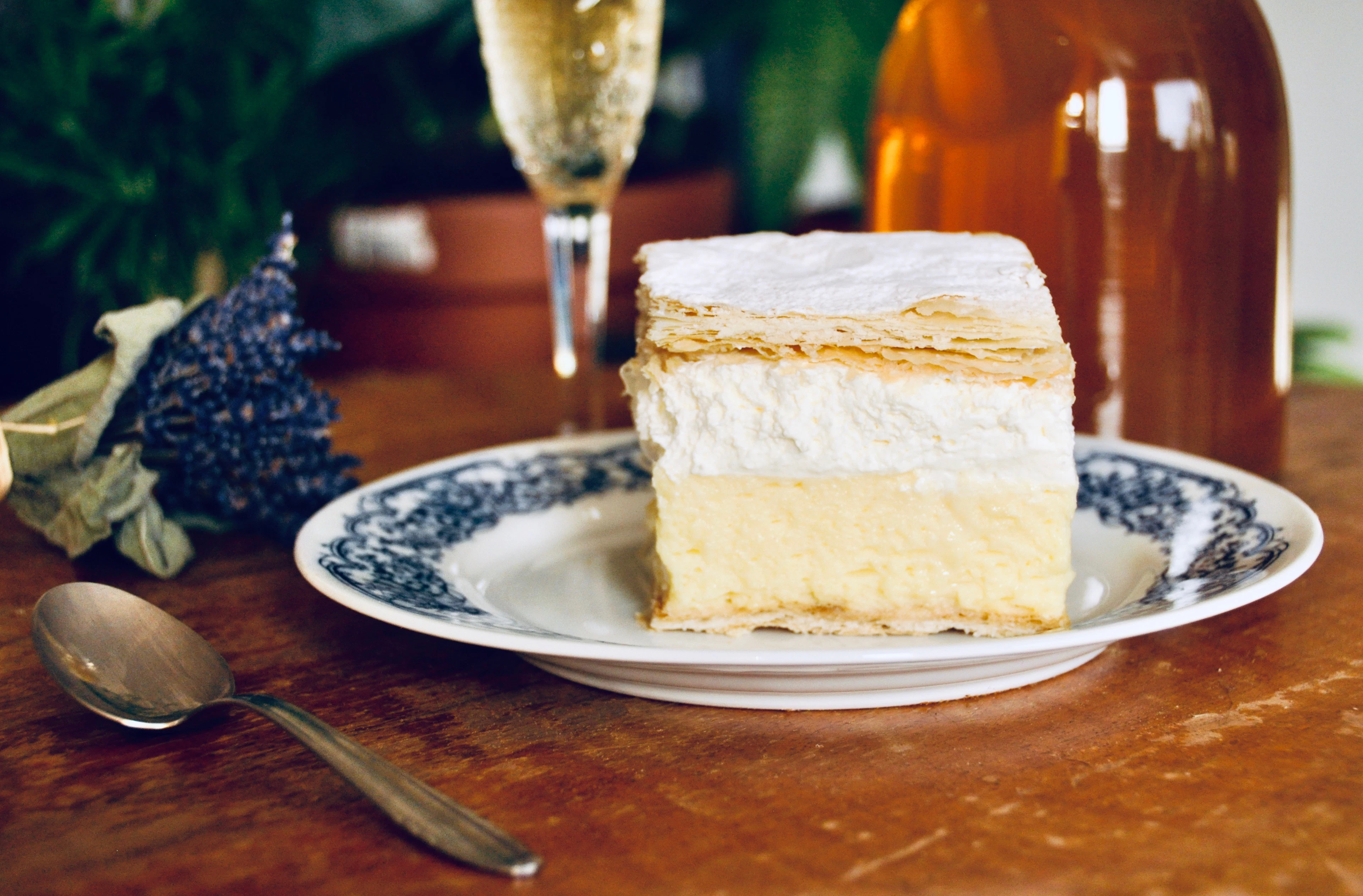 A slice of kremsnita, the Bled cream cake - custard and whipped cream between layers of puff pastry - on a patterned plate in Bled, Slovenia
