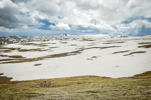 Scene showcasing an open-world exploration game with detailed terrain and weather effects