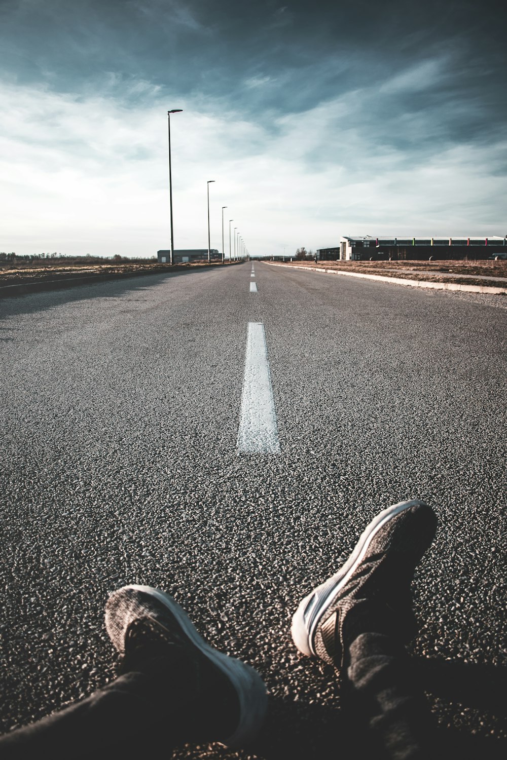 person sitting on empty road